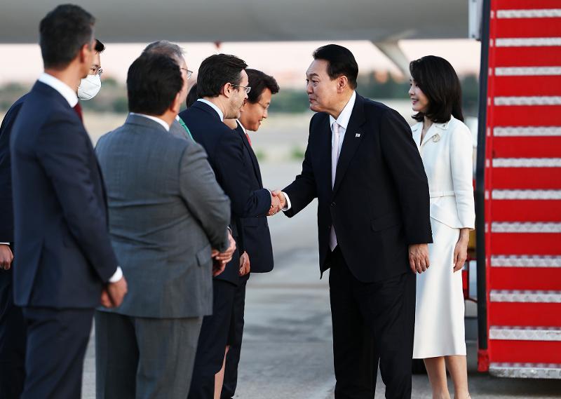 President Yoon Suk Yeol (second from right) on June 27 shakes hands with reception officials after arriving at the Adolfo Suarez Madrid–Barajas Airport in Madrid, Spain. (Yonhap News)