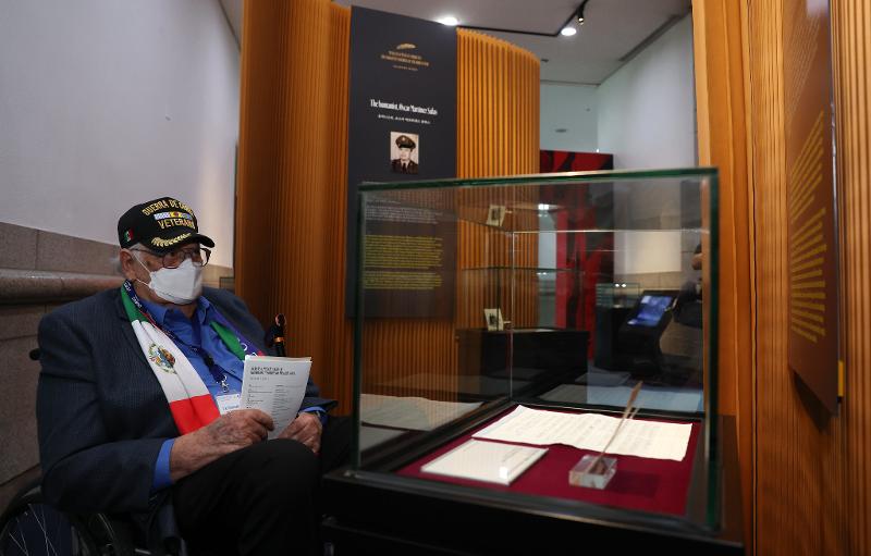 Mexican veteran Antonio Lozano Bustos on June 28 is buried in thought while looking at the notes he donated to the exhibition on Mexican and Mexican American veterans of the Korean War, 