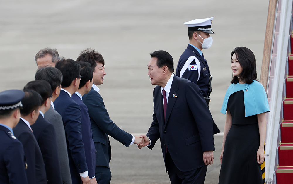 President Yoon Suk Yeol (second from right), who arrived on July 1 with first lady Kim Keon Hee at Seoul Air Base in Seongnam, Gyeonggi-do Province, after a five-day trip to Madrid, Spain, shakes hands with Rep. Lee Jun Seok, chairman of the People Power Party.
