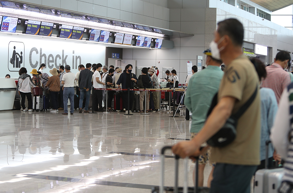 Passengers on July 14 check in at the international departure gate of Muan International Airport in Muan-gun County, Jeollanam-do Province.