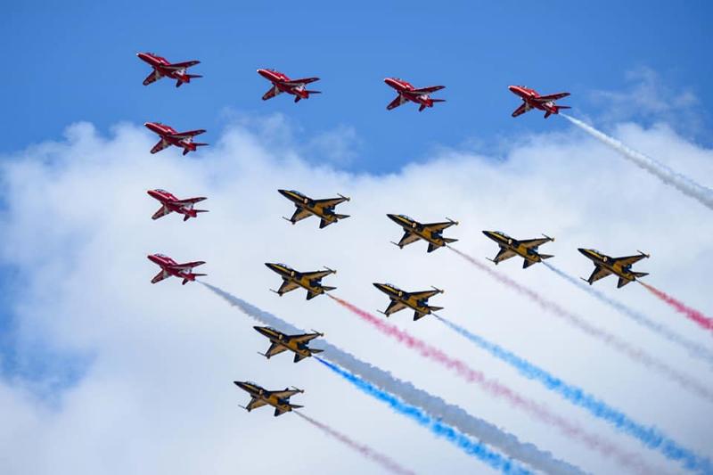 The Black Eagles, the Republic of Korea Air Force's aerobatic flight team, performs in a friendly flight with their British counterparts Red Arrows at the Royal International Air Tattoo airshow in Fairford, a town in the county of Gloucestershire, the U.K.