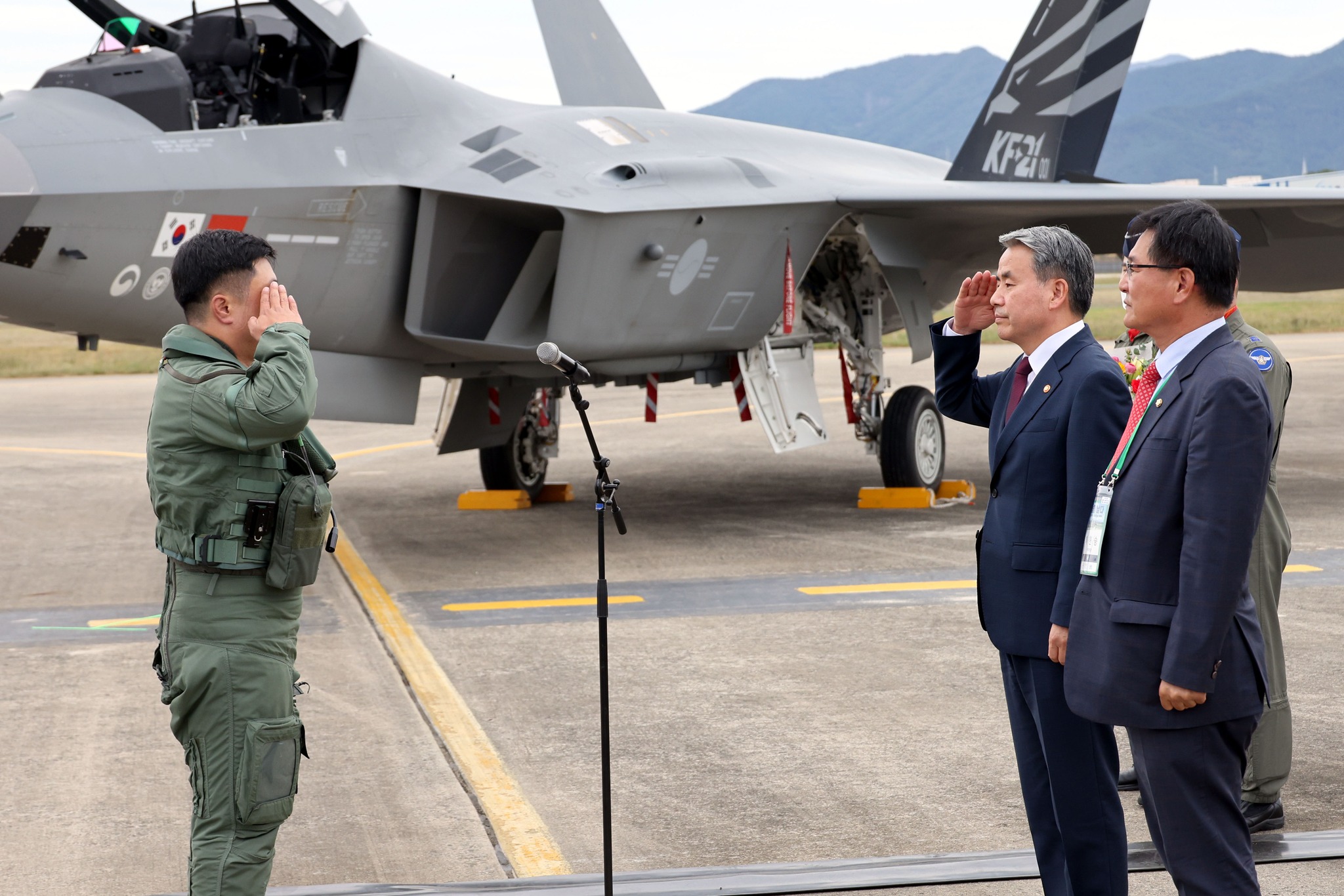 Maj. Ahn Jun-hyun (left) of the Republic of Korea Air Force, who piloted the No. 1 prototype of the KF-21 fighter jet, salutes Minister of National Defense Lee Jong-Sup (second from right) after navigating the jet's first public test flight at the 3rd Flying Training Wing of Sacheon Air Force Base in Sacheon, South Gyeongsang Province.  