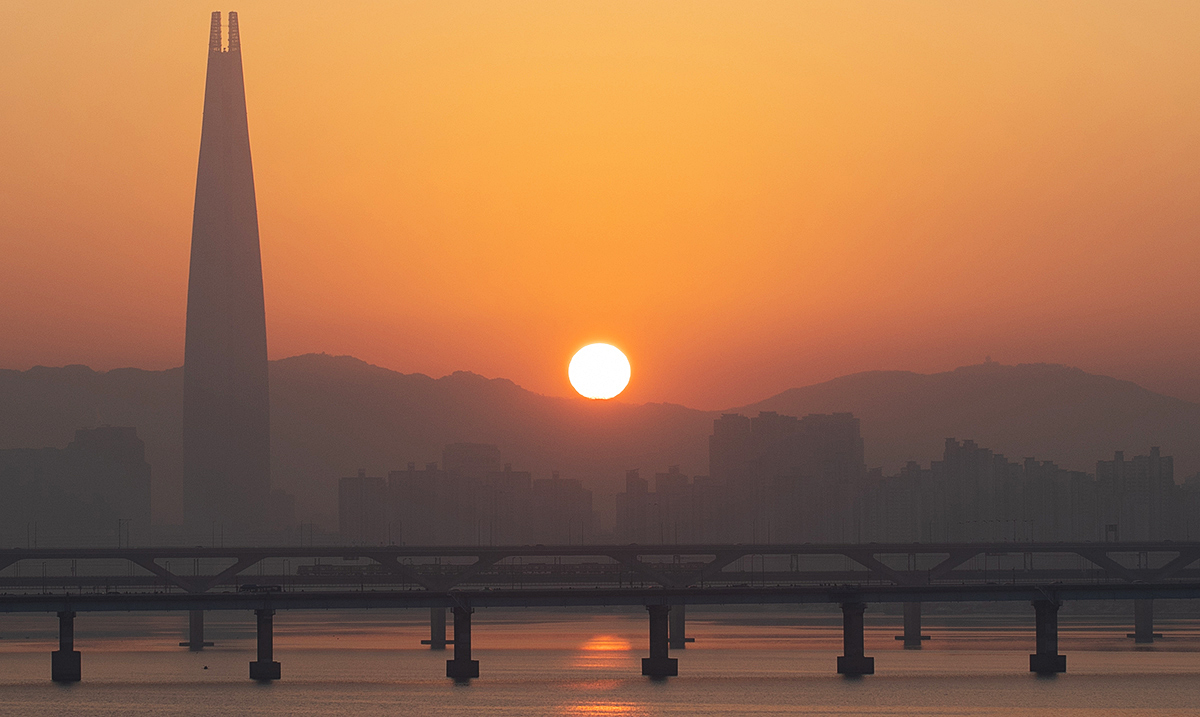 'The first sunrise of the new year on Jan. 1 rises in the morning above a bridge next to Seoul Forest in the capital's Seongdong-gu District. 