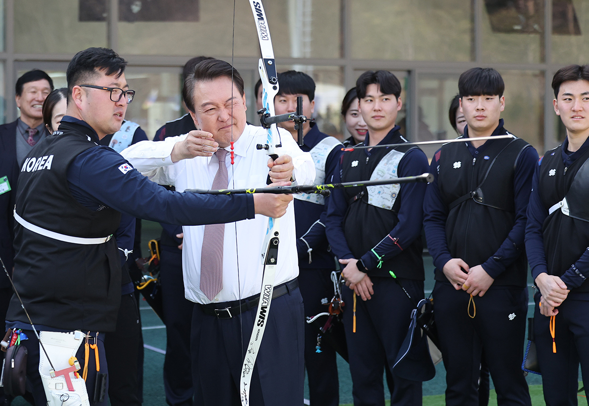 President Yoon Suk Yeol on Feb. 14 draws a bowstring at the archery range of Jincheon National Training Center in Jincheon-gun County, Chungcheongbuk-do Province, after receiving a briefing on this year's national vision for sports.