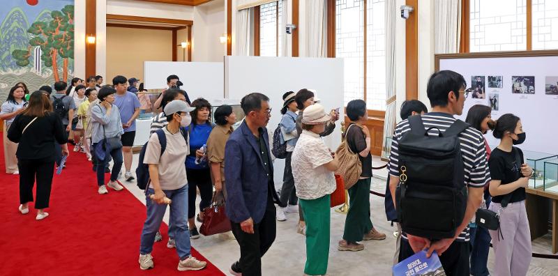 Visitors on June 4 look around at the exhibition 