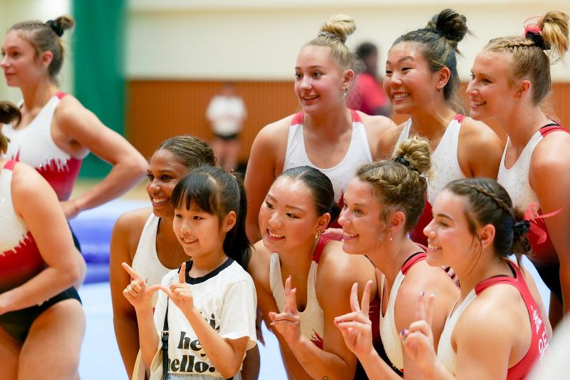The U.S. women's gymnastics team Red Rocks after its showcase on July 1 take commemorative photos with a child who attended the event at the IGC's gymnasium in the Songdo International Business District of Incheon.