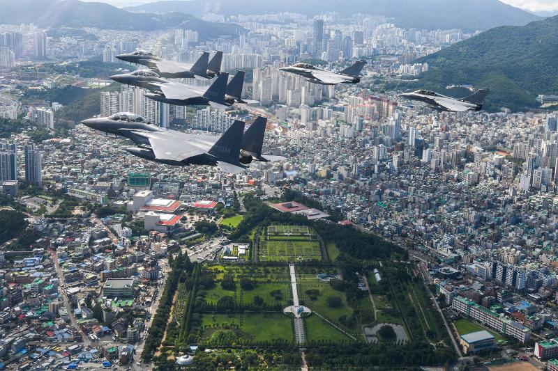 Three F-15K fighter jets of the Republic of Korea Air Force and two Rafale combat aircraft of the French Air and Space Force conduct a flypast over the U.N. Memorial Cemetery in the Nam-gu District of Busan on July 25. (Republic of Korea Air Force) 