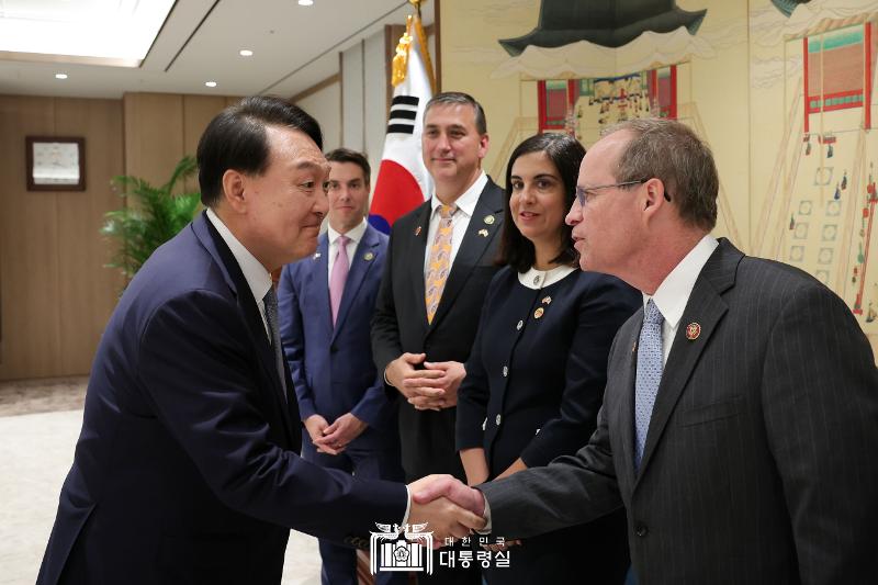 President Yoon Suk Yeol (left) on July 31 shakes hands with a member of a visiting delegation from the U.S. House of Representatives at the Office of the President in Seoul's Yongsan-gu District. (Office of the President) 