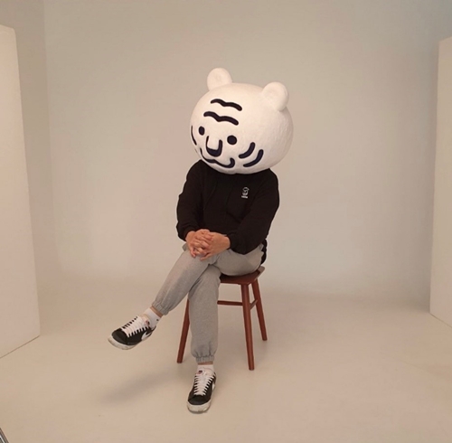 Webtoonist Kim Bo-tong poses for a photo in a white tiger costume that symbolizes his content production company Studio Tiger. (Kim's official Instagram account)