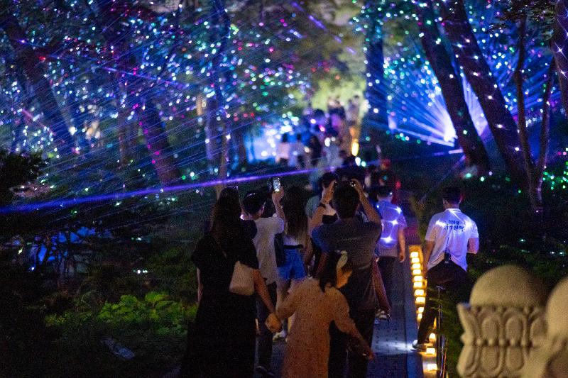 Visitors take photos of an illuminated section of Cheong Wa Dae during the tour 