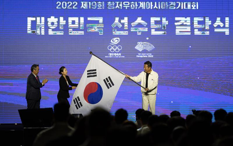 Choi Yoon, head of the national delegation for the 19th Asian Games in Hangzhou, China, on Sept. 12 waves the national flag at the launching ceremony for the squad at Olympic Hall of Olympic Park in Seoul's Songpa-gu District.
