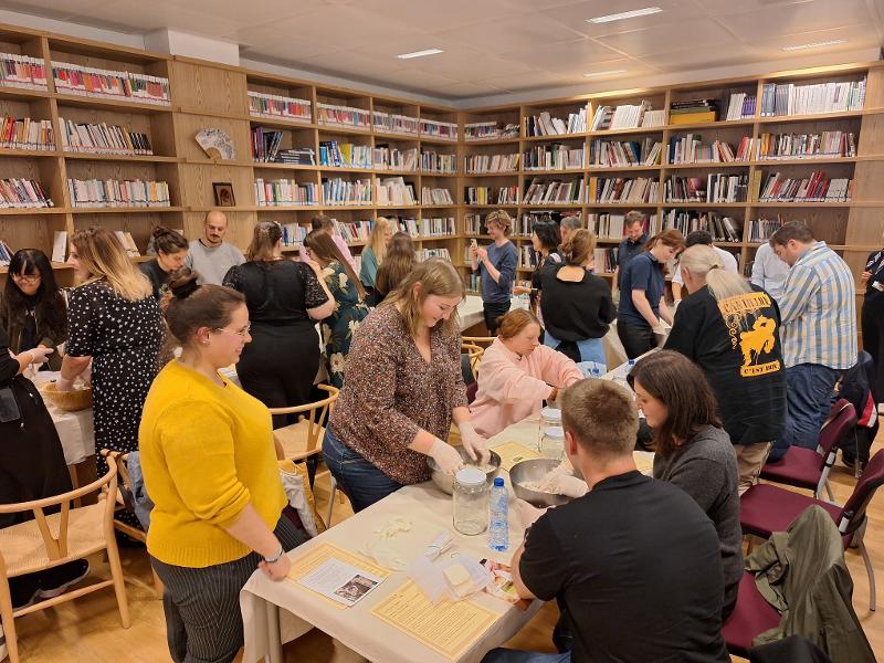Participants in a makgeolli event on Sept. 25 try their hand at making the milky rice wine at the Korean Cultural Center in Brussels, Belgium.
