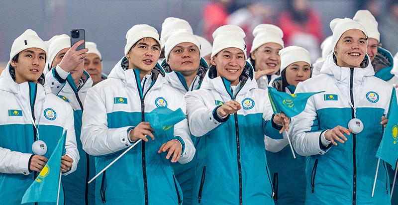The Kazakh national team on Jan. 19 smiles as members enter the venue for Gangwon 2024's opening ceremony. 
