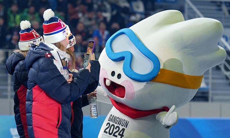 Members of the Norwegian national team on Jan. 19 take photos of the competition's mascot Moongcho with their smartphones as the character welcomes their arrival at Gangwon 2024's opening ceremony held at the Gangneung Oval in Gangneung, Gangwon-do Province..