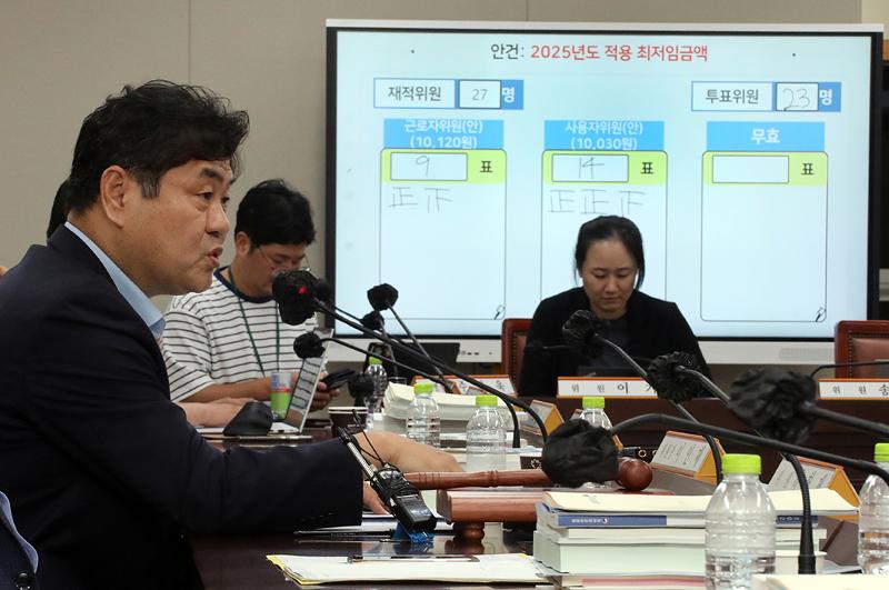The Minimum Wage Commission on July 12 set the minimum hourly wage for next year at KRW 10,030. Shown is the commission's chairman Lee In-je (left) in the early morning hours of July 12 answering questions from journalists after holding a meeting of the body at Government Complex-Sejong. (Yonhap News) 