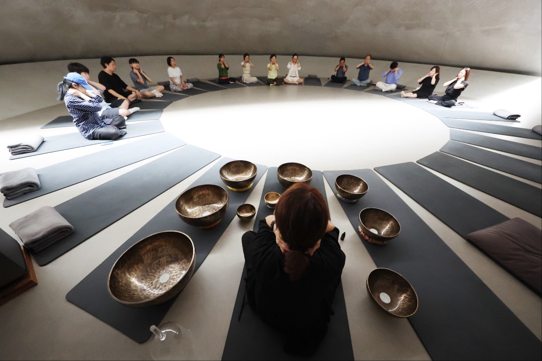 Participants in the Gangwon Wellness Festa on July 22 meditate at Museum San in Wonju, Gangwon-do Province.