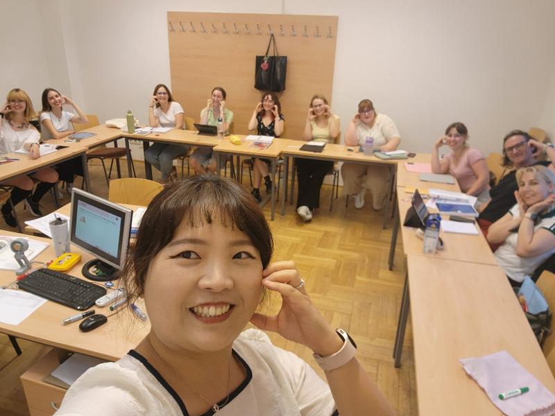 Teacher Park Insun poses for a group selfie with her students in a course on practical Korean at King Sejong Institute's branch in Budapest, Hungary, ahead of the institute's graduation ceremony for the second half of 2025. (Park Insun)