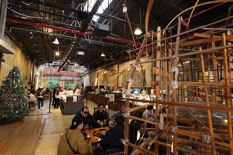 Customers on Dec. 9 spend time at a cafe whose building was once a factory.