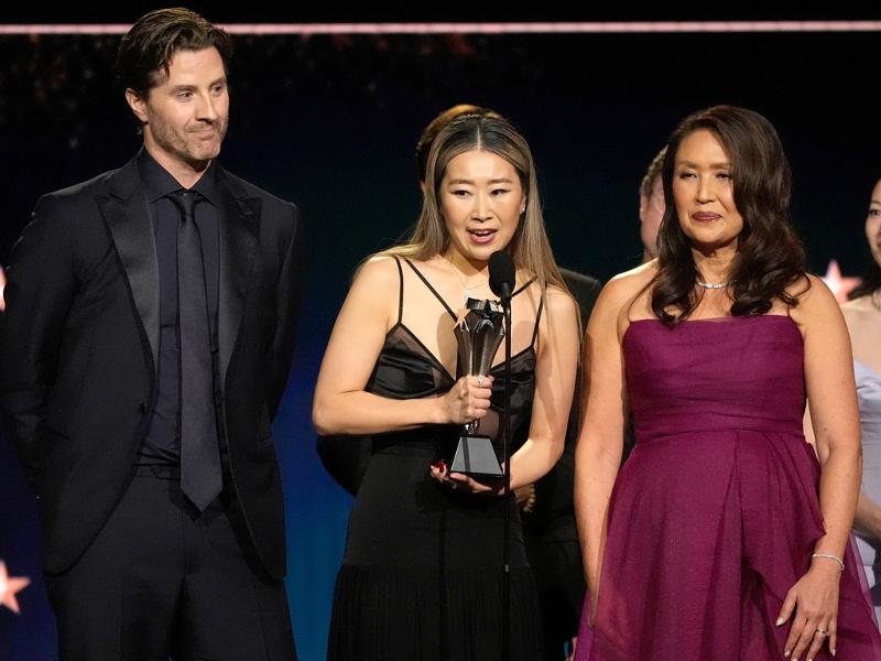 Maggie Kang (center), the Korean Canadian creator and co-director of the animated blockbuster 
