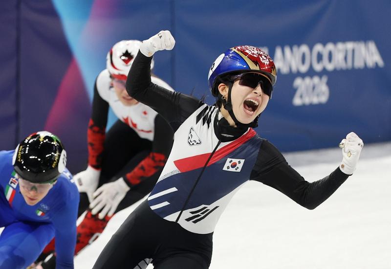 Kim Gilli on Feb. 18 celebrates while crossing the finish line first in the final of the women's 3,000-m short track relay at the Milano Ice Skating Arena in Milan at the Milan Cortina Winter Olympics in Italy. 