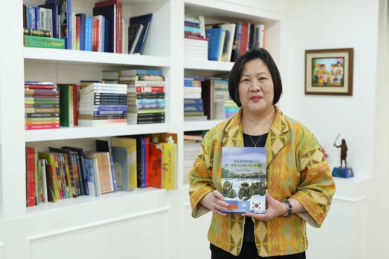 Philippine Ambassador to Korea Bernadette Therese C. Fernandez on Feb. 26 holds a book on Philippine soldiers who died in the Korean War at her office in Seoul’s Jung-gu District. 