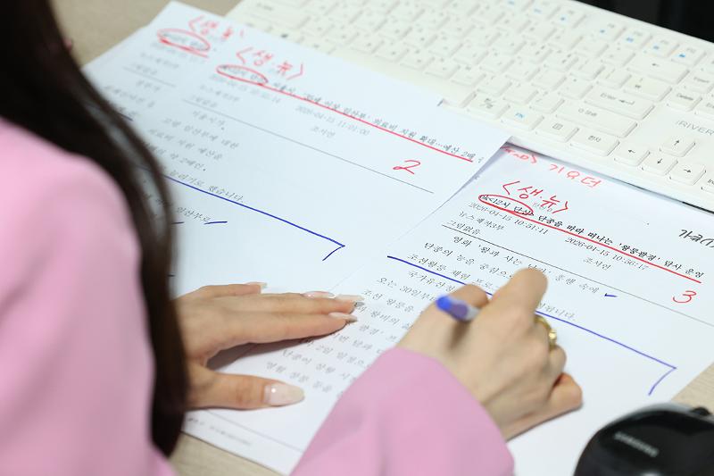 Roh Heeji reviews her script before a live broadcast.
