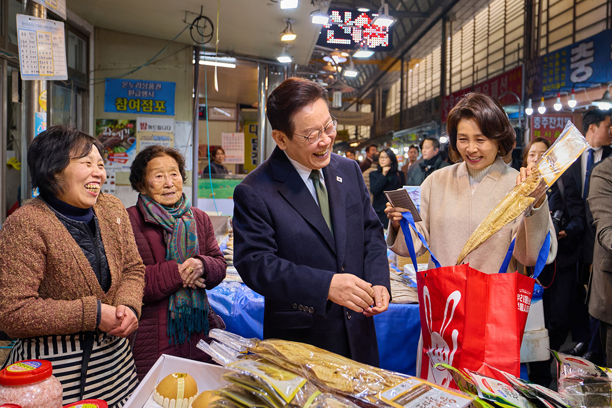 President Lee Jae Myung (third from left) and first lady Kim Hea Kyung on Feb. 11 check prices and buy traditional goods at Muhak Market in Chungju, Chungcheongbuk-do Province, ahead of the Seollal (Lunar New Year) holidays. (Cheong Wa Dae)