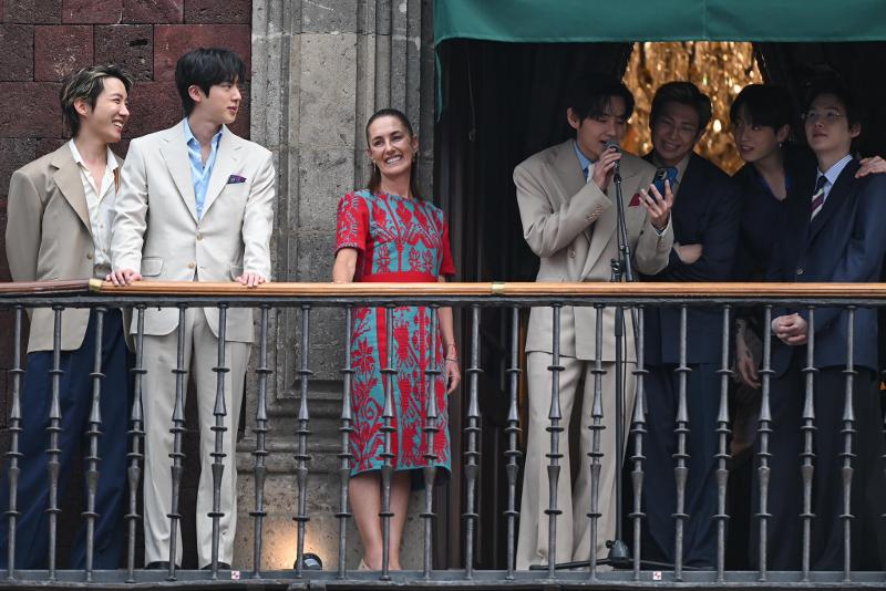 BTS and Mexican President Claudia Sheinbaum Pardo (third from left) on May 6 wave to K-pop group's fans and the public from the balcony of the official presidential residence National Palace in Mexico City. 
